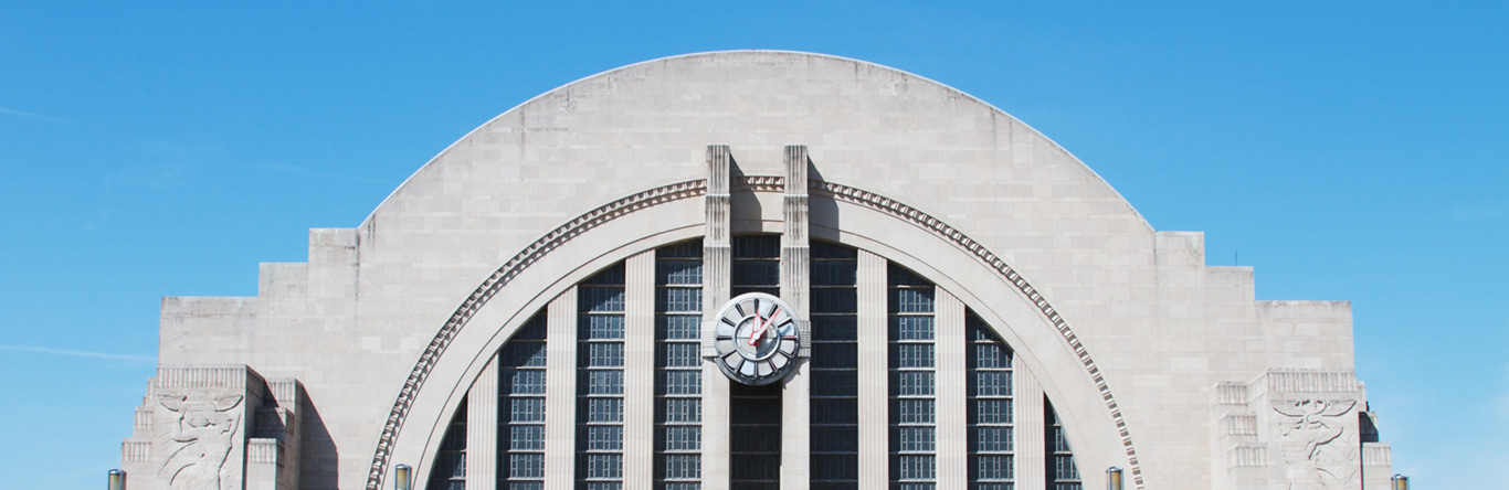 arched stone building with clock